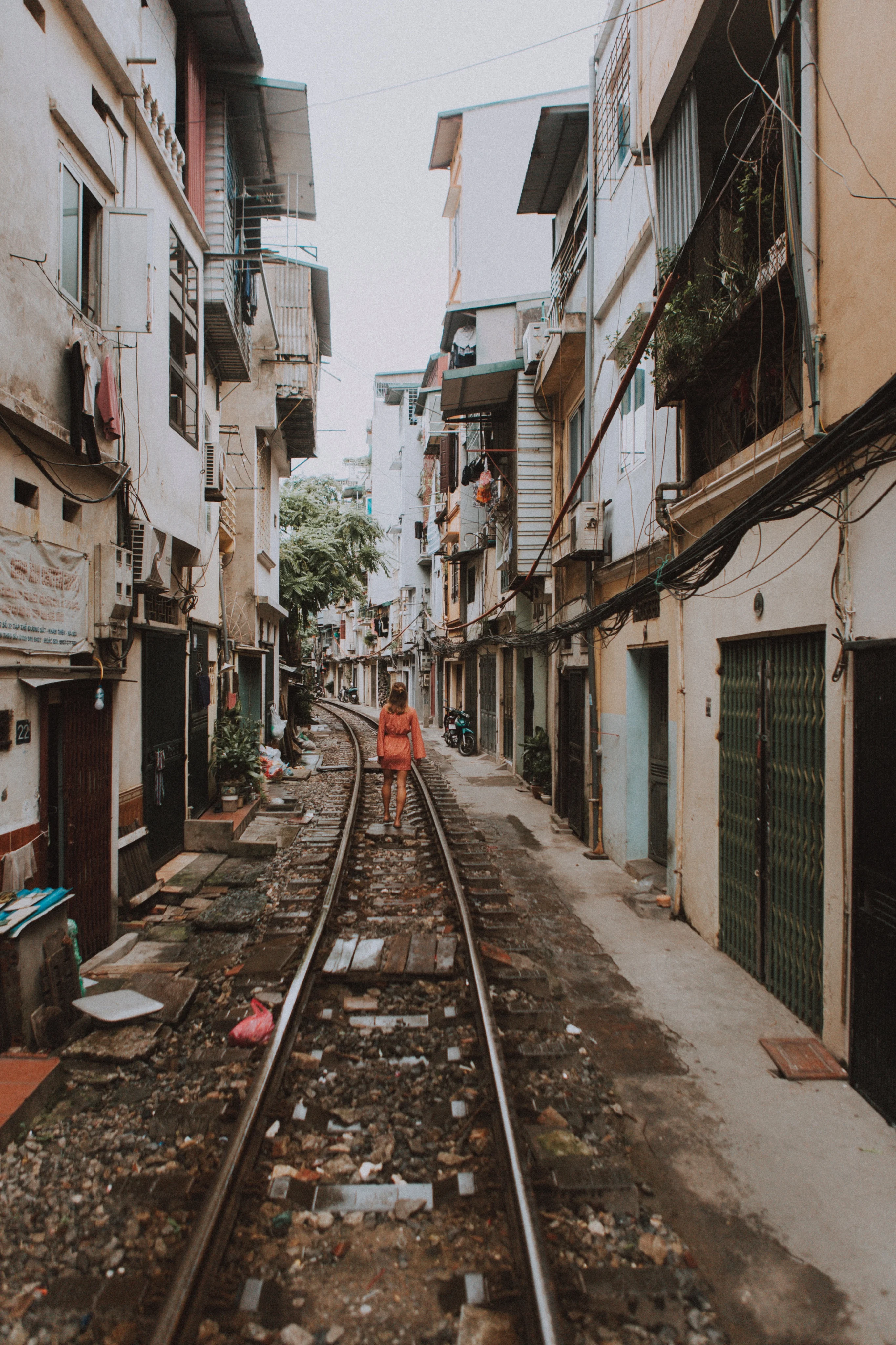 Phung Hung Train Street alley with colourful murals and outdoor cafe tables